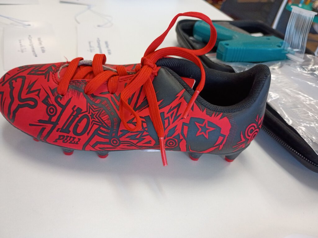 Red and Black Soccer Cleats with Graphic Design